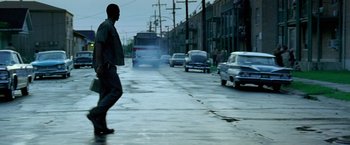 Movie still from “Glory Road” (2006), directed by James Gartner – A man walking down the street in the middle of the day; Wide shot, Low angle