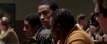 Movie still from “Glory Road” (2006), directed by James Gartner – A group of young men sitting next to each other in a room; Close Up shot, Over the shoulder angle