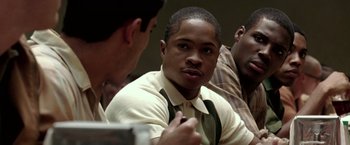 Movie still from “Glory Road” (2006), directed by James Gartner – A man in a white shirt and tie talking to two other men; Close Up shot, Over the shoulder angle