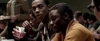 Movie still from “Glory Road” (2006), directed by James Gartner – A group of young men sitting next to each other; Close Up shot, Over the shoulder angle