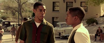 Movie still from “Glory Road” (2006), directed by James Gartner – Two young men standing next to each other on the street; Medium shot, Over the shoulder angle