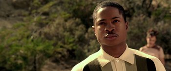 Movie still from “Glory Road” (2006), directed by James Gartner – A man with a mustache is standing in front of a tree; Close Up shot, High angle