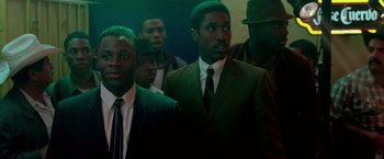 Movie still from “Glory Road” (2006), directed by James Gartner – A group of men standing next to each other in a room; Medium shot, High angle