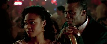 Movie still from “Glory Road” (2006), directed by James Gartner – A man and a woman sitting next to each other in a room; Close Up shot, Over the shoulder angle