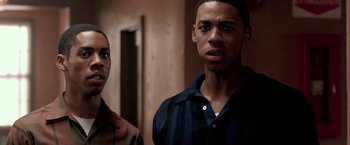 Movie still from “Glory Road” (2006), directed by James Gartner – A man and a woman standing next to each other in a room; Close Up shot, Over the shoulder angle