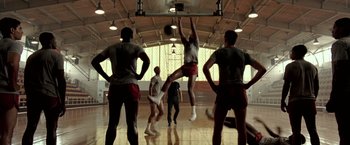 Movie still from “Glory Road” (2006), directed by James Gartner – A group of young men playing a game of basketball; Wide shot, Low angle