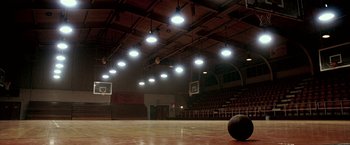 Movie still from “Glory Road” (2006), directed by James Gartner – An empty basketball court in a large gymnasium; Extreme Wide shot, High angle