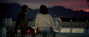 Movie still from “Glory Road” (2006), directed by James Gartner – A man and a woman sitting at a table with candles; Medium shot, High angle