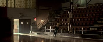 Movie still from “Glory Road” (2006), directed by James Gartner – A man standing in front of an audience in a gym; Extreme Wide shot, Low angle