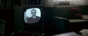 Movie still from “Glory Road” (2006), directed by James Gartner – An old television with a picture of a man on it; Close Up shot, Over the shoulder angle