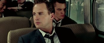 Movie still from “Glory Road” (2006), directed by James Gartner – A man in a suit and tie sitting next to another man in a suit and tie; Close Up shot, Over the shoulder angle
