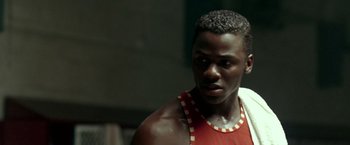 Movie still from “Glory Road” (2006), directed by James Gartner – A person wearing a tank top; Close Up shot, Over the shoulder angle