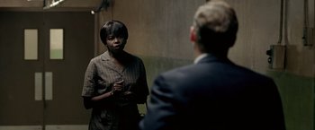 Movie still from “Glory Road” (2006), directed by James Gartner – A woman standing in front of a mirror talking to a man; Medium shot, Over the shoulder angle