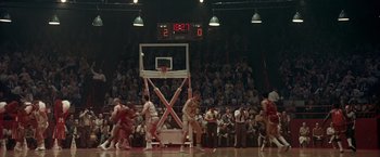 Movie still from “Glory Road” (2006), directed by James Gartner – A group of men playing a game of basketball on a court; Extreme Wide shot, High angle