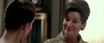 Movie still from “Glory Road” (2006), directed by James Gartner – A woman in a green dress talking to a man in a black suit; Close Up shot, Over the shoulder angle