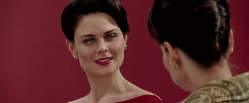 Movie still from “Glory Road” (2006), directed by James Gartner – A woman in a red dress looking at her reflection in a mirror; Close Up shot, Over the shoulder angle