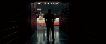 Movie still from “Glory Road” (2006), directed by James Gartner – A man standing in a tunnel with a basketball hoop; Wide shot, Low angle