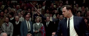 Movie still from “Glory Road” (2006), directed by James Gartner – A crowd of people are gathered in a room; Medium shot, High angle