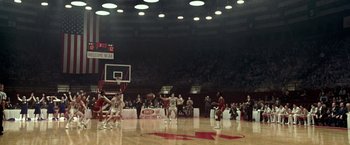 Movie still from “Glory Road” (2006), directed by James Gartner – A group of men playing a game of basketball on a basketball court; Extreme Wide shot, High angle