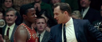 Movie still from “Glory Road” (2006), directed by James Gartner – A man in a suit talking to another man in a suit; Close Up shot, Over the shoulder angle