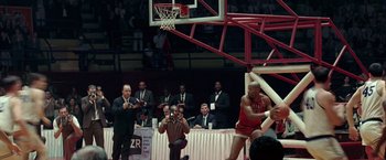 Movie still from “Glory Road” (2006), directed by James Gartner – A basketball player is in mid air during a basketball game; Wide shot, High angle