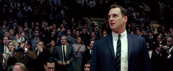 Movie still from “Glory Road” (2006), directed by James Gartner – A man in a suit standing in front of an audience; Close Up shot, Low angle