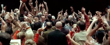 Movie still from “Glory Road” (2006), directed by James Gartner – A group of people standing in front of each other with their hands in the air; Wide shot, High angle