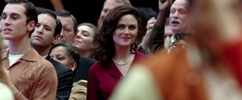 Movie still from “Glory Road” (2006), directed by James Gartner – A woman in a crowd of people wearing a red dress; Close Up shot, Over the shoulder angle