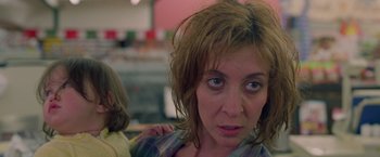 Movie still from “Go” (1999), directed by Doug Liman – A person with her head down; Close Up shot, Low angle