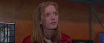 Movie still from “Go” (1999), directed by Doug Liman – A woman with long blonde hair wearing a red leather jacket; Close Up shot, Low angle
