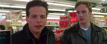 Movie still from “Go” (1999), directed by Doug Liman – A man and a woman standing in front of shelves of candy; Close Up shot, Over the shoulder angle