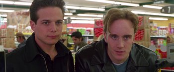 Movie still from “Go” (1999), directed by Doug Liman – Two young men are posing for a picture in a store; Close Up shot, Low angle