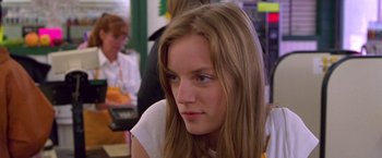 Movie still from “Go” (1999), directed by Doug Liman – A person with long brown hair; Close Up shot, Low angle