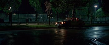 Movie still from “Go” (1999), directed by Doug Liman – A truck driving down a street at night; Extreme Wide shot, Low angle