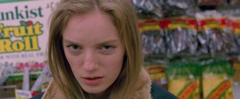 Movie still from “Go” (1999), directed by Doug Liman – A person wearing a jacket; Close Up shot, Low angle