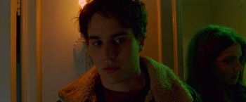 Movie still from “Go” (1999), directed by Doug Liman – A young man in a brown jacket looking at the camera; Close Up shot, Low angle