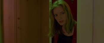 Movie still from “Go” (1999), directed by Doug Liman – A woman with green hair looking at the camera; Close Up shot, Low angle