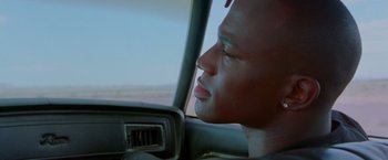 Movie still from “Go” (1999), directed by Doug Liman – A person in a car looking out the window; Close Up shot, Low angle