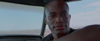 Movie still from “Go” (1999), directed by Doug Liman – A person sitting in a car; Close Up shot, Low angle