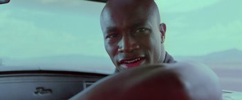 Movie still from “Go” (1999), directed by Doug Liman – A person in a car; Close Up shot, Low angle