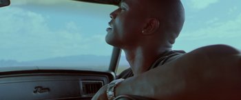 Movie still from “Go” (1999), directed by Doug Liman – A person sitting in a car; Close Up shot, Low angle