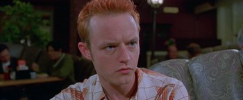 Movie still from “Go” (1999), directed by Doug Liman – A person with red hair; Close Up shot, High angle