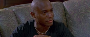 Movie still from “Go” (1999), directed by Doug Liman – A person sitting on a couch; Close Up shot, High angle