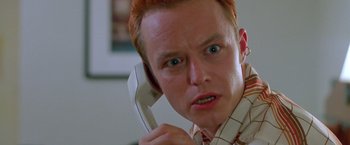 Movie still from “Go” (1999), directed by Doug Liman – A man holding a phone up to his ear; Close Up shot, Low angle