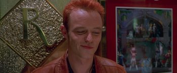 Movie still from “Go” (1999), directed by Doug Liman – A person with red hair; Close Up shot, Low angle