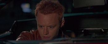 Movie still from “Go” (1999), directed by Doug Liman – A person with red hair; Close Up shot, High angle