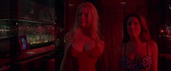 Movie still from “Go” (1999), directed by Doug Liman – A woman in a red dress posing for the camera; Medium shot, Low angle