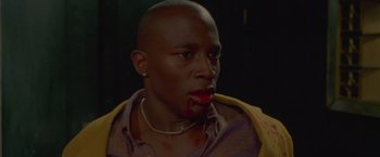 Movie still from “Go” (1999), directed by Doug Liman – A person with blood on his mouth; Close Up shot, Low angle
