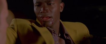 Movie still from “Go” (1999), directed by Doug Liman – A person with blood on his face; Close Up shot, Low angle