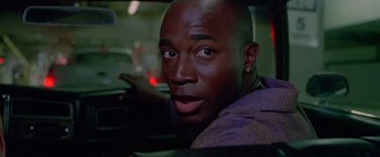 Movie still from “Go” (1999), directed by Doug Liman – A person sitting in a car; Close Up shot, Low angle